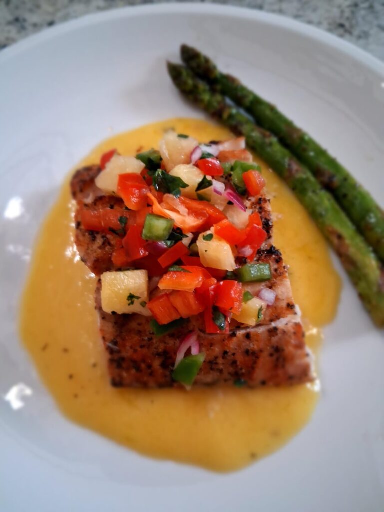 Grilled mahi mahi over mango butter topped with pineapple salsa with a side of lemon pepper asparagus 😁