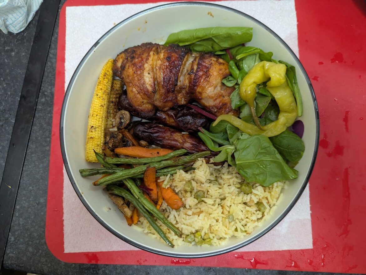 Grilled chicken, sausages, rice & peas, roast veg and salad.