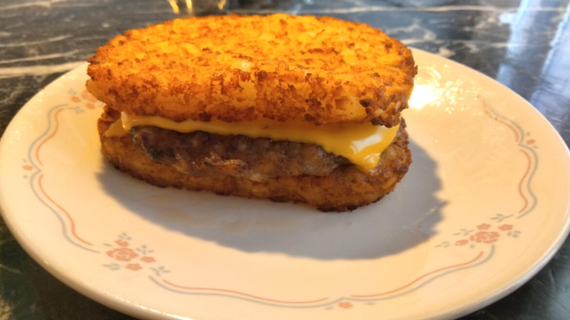 Sausage patty and American cheese between two hash brown panties