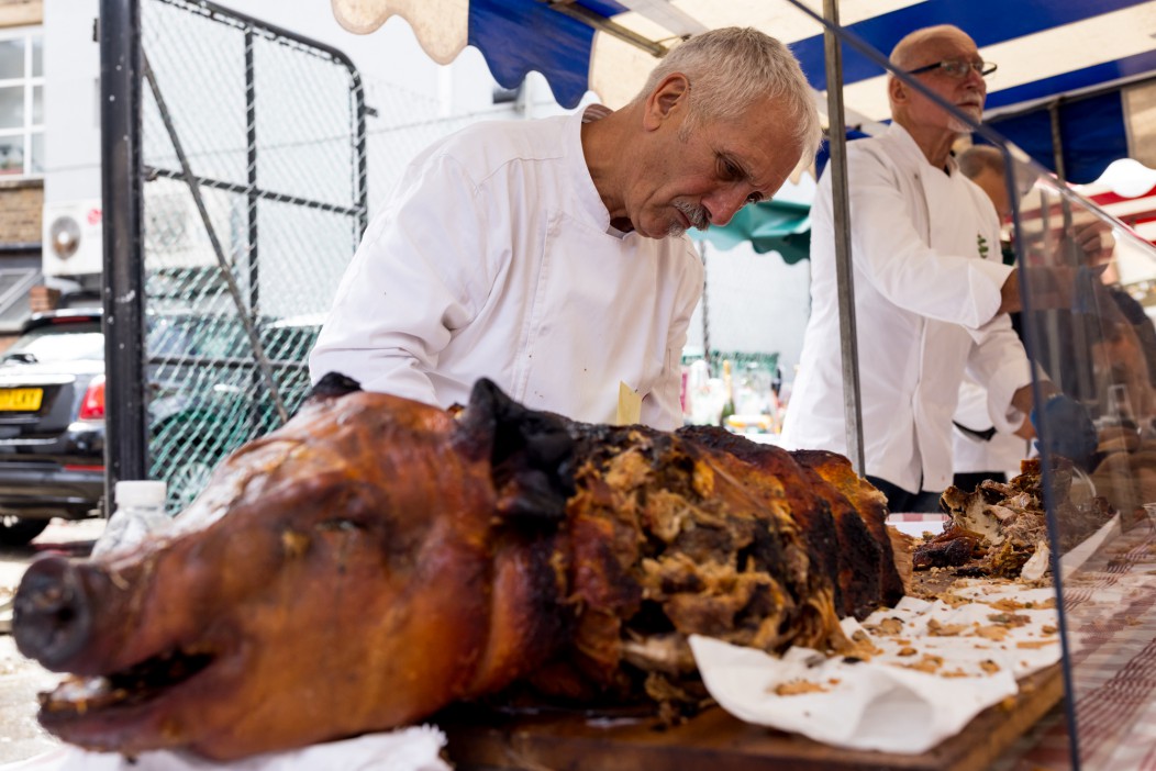 A chef carving porchetta.