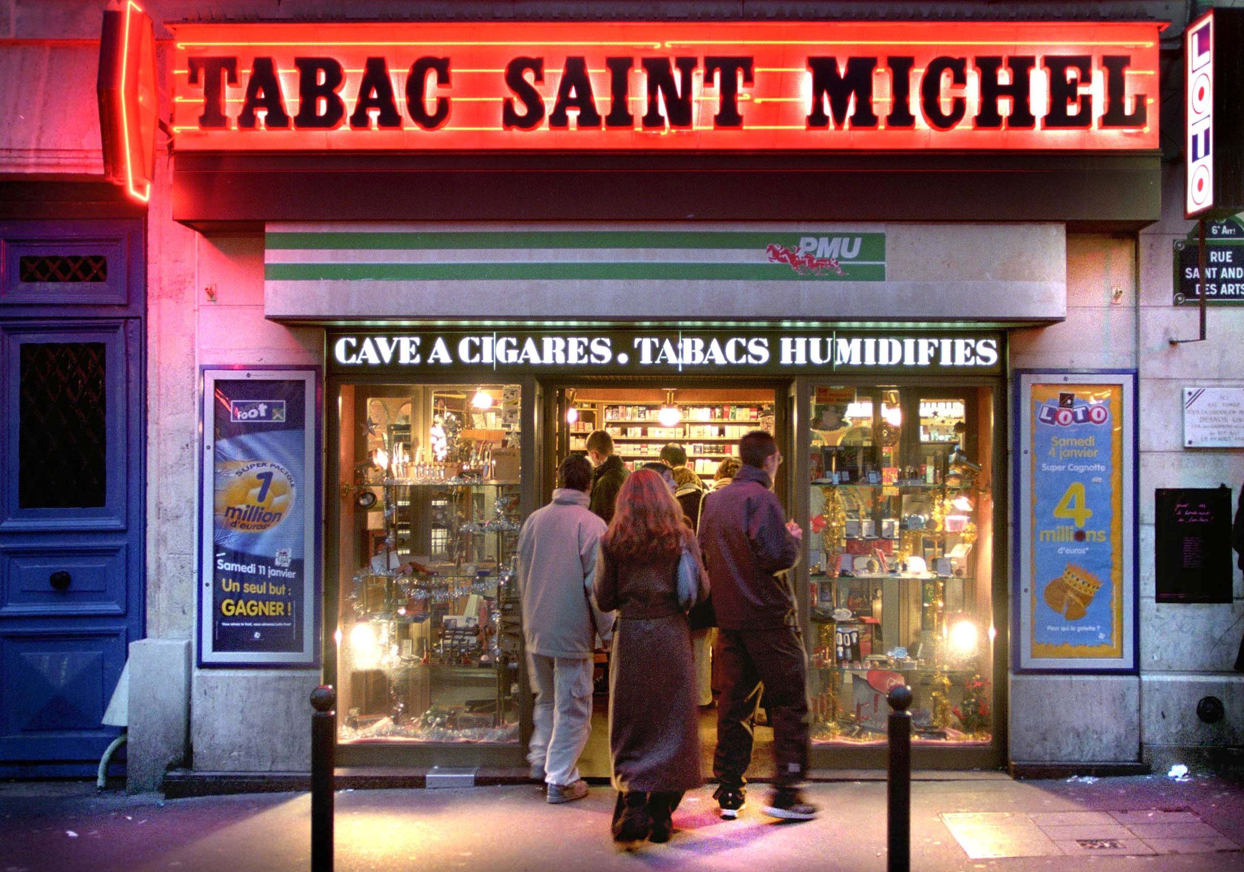 People queuing outside a Parisian tabac to buy cigarettes.