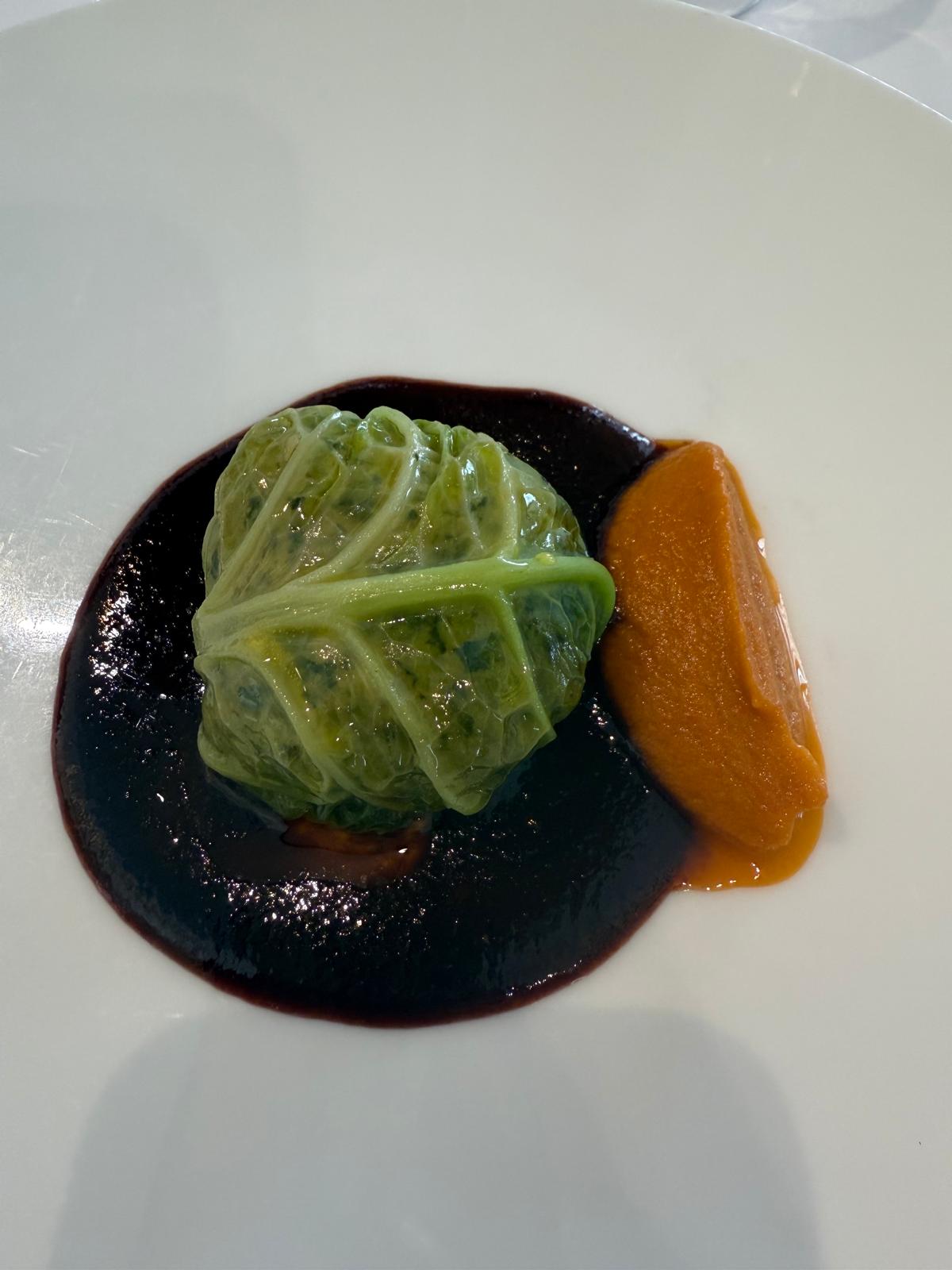 Stuffed cabbage with sauce and purée.