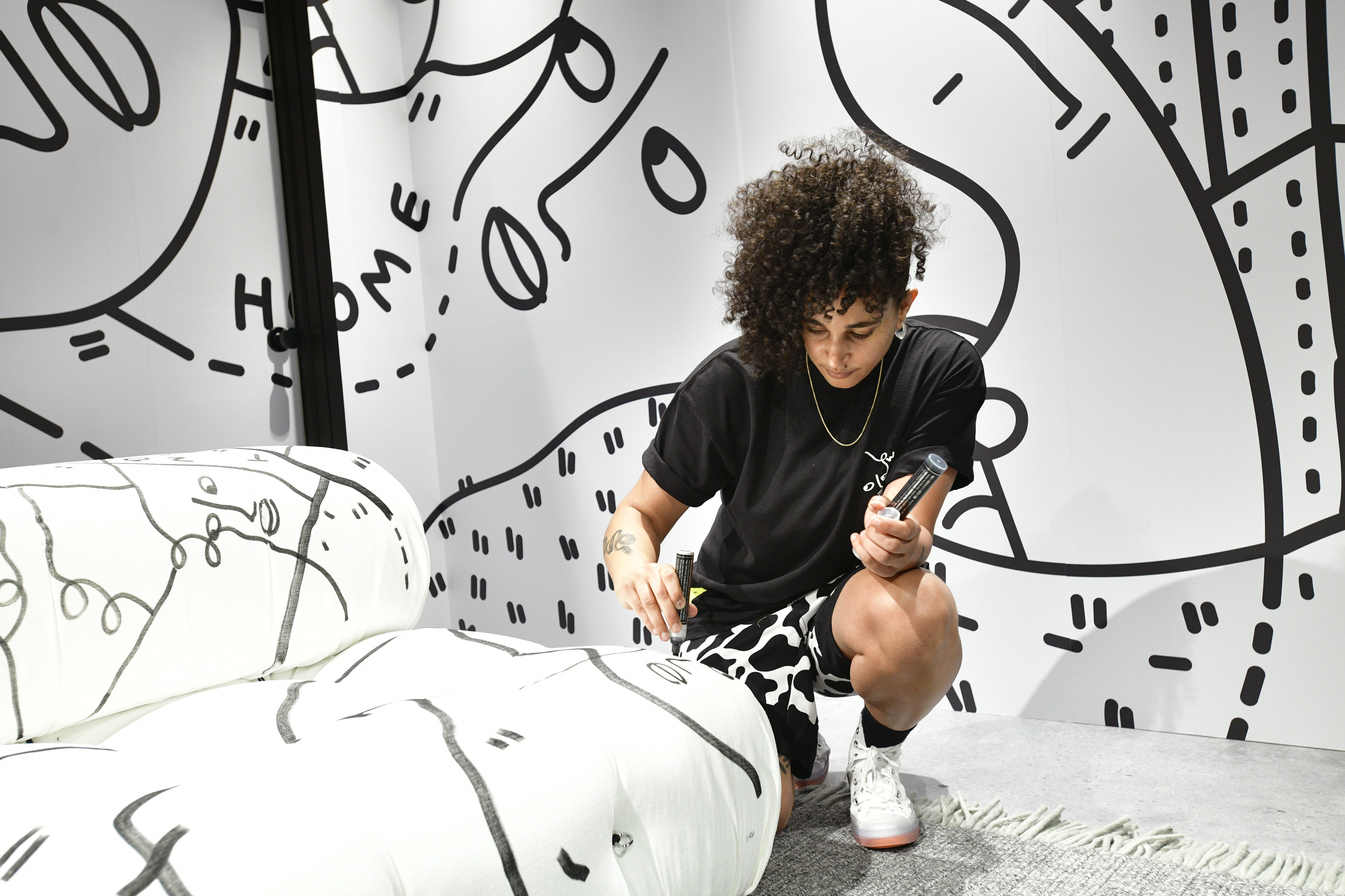 Shantell Martin drawing on a piece of furniture.