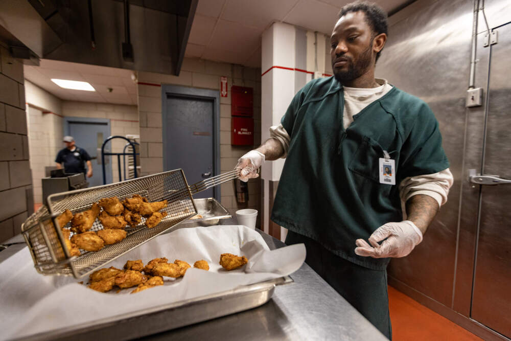 David Peters works to perfect his spicy chicken wings during a culinary class at Norfolk County Correctional Center. (Jesse Costa/WBUR)