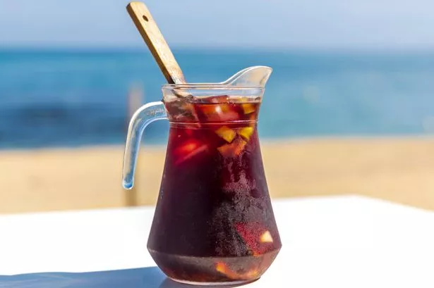 Typical Spanish drink "Sangria" made of red wine, fruit and alcohol, on a sunny day on the beach