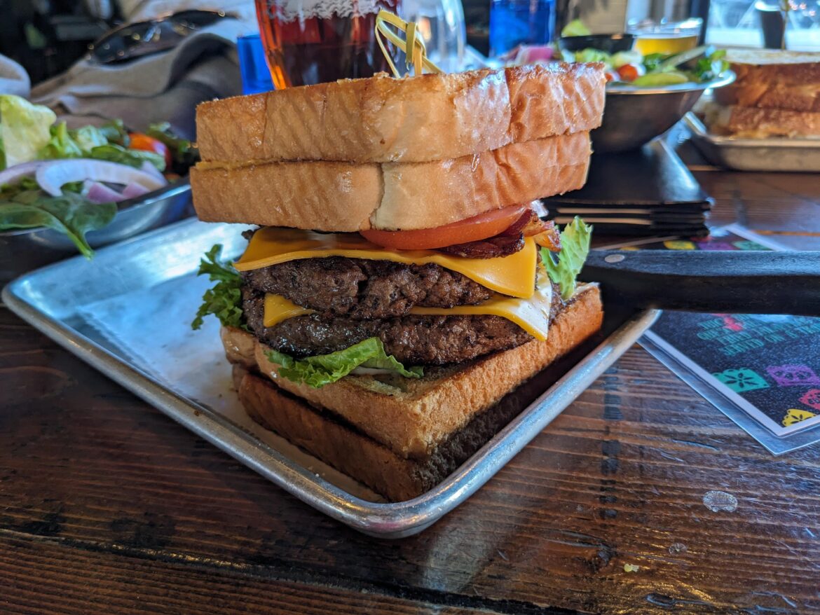 It's not a melt. Just two grilled cheeses keeping a couple burgers in line.