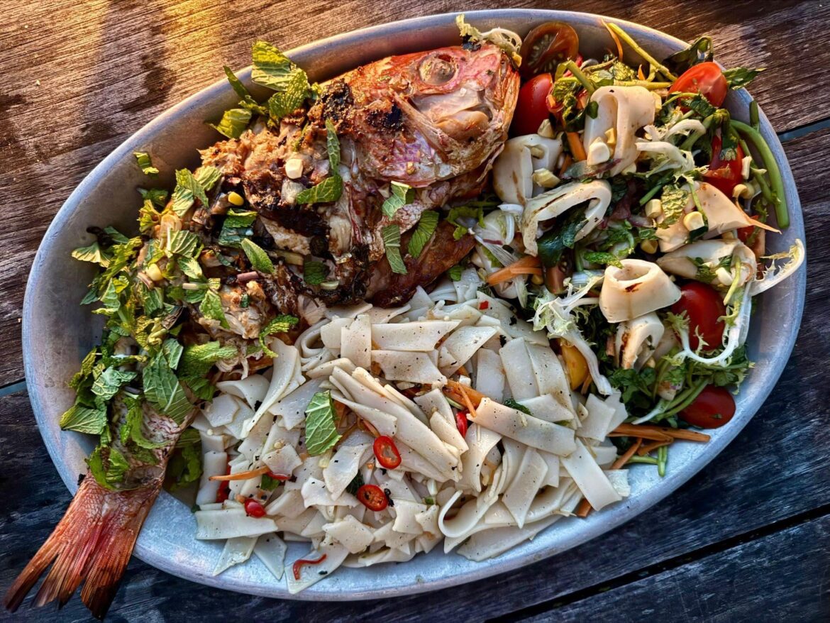 Red snapper with tamarind marinade, grilled squid salad and some rice noodles stir fried on the grill.