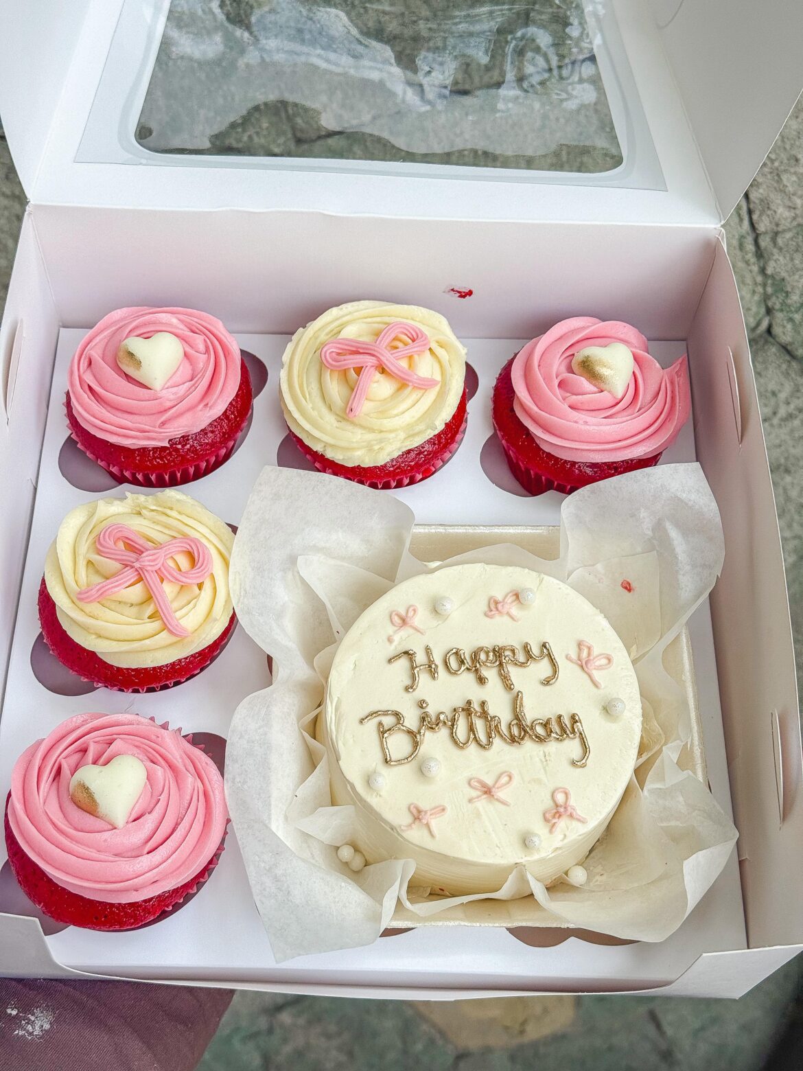 Cake accompanied by cupcakes