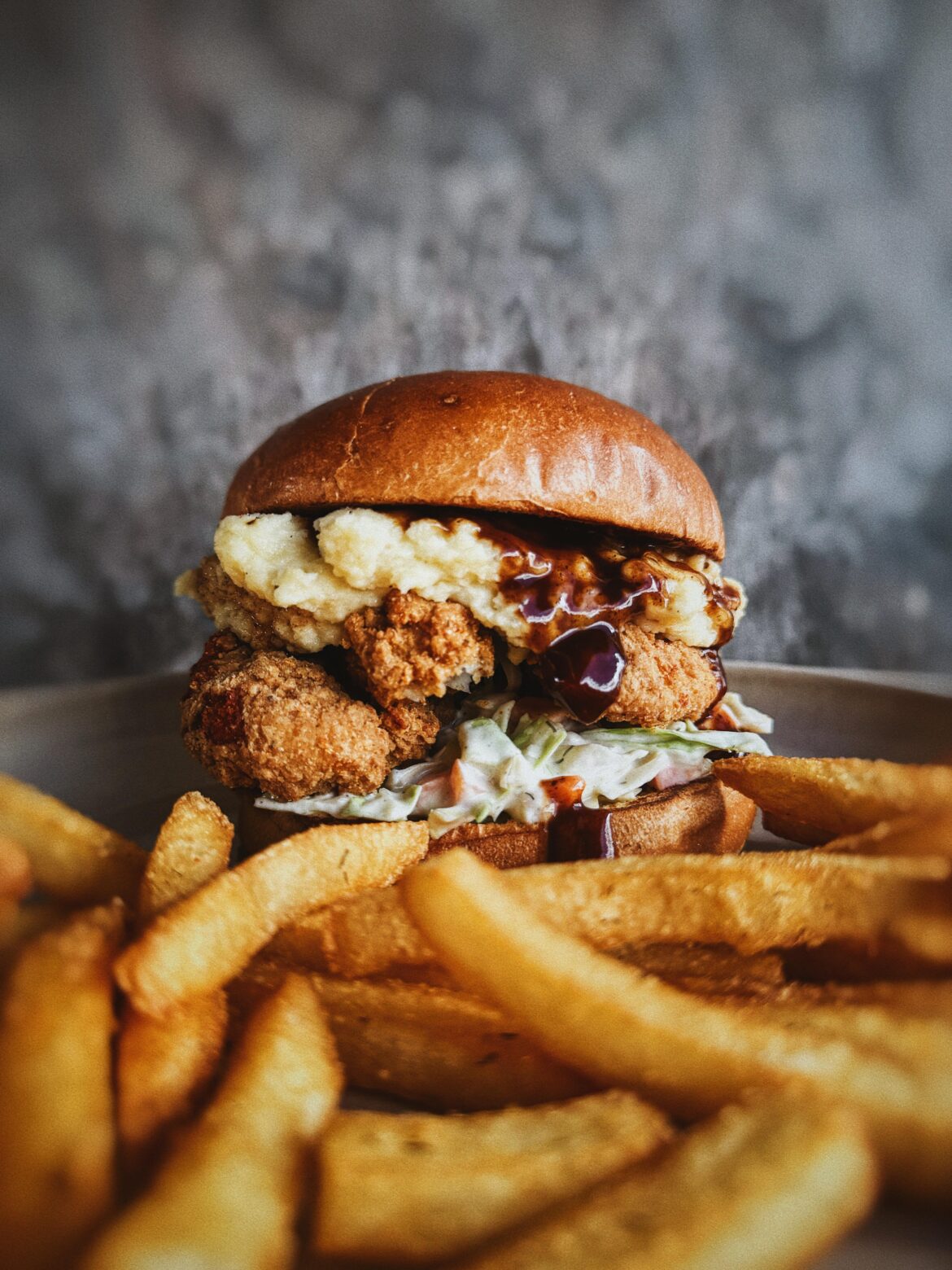 Creamy slaw, fried chicken thigh, roasted garlic mashed potato, reduced chicken jus, soft potato bun, chicken salt fries