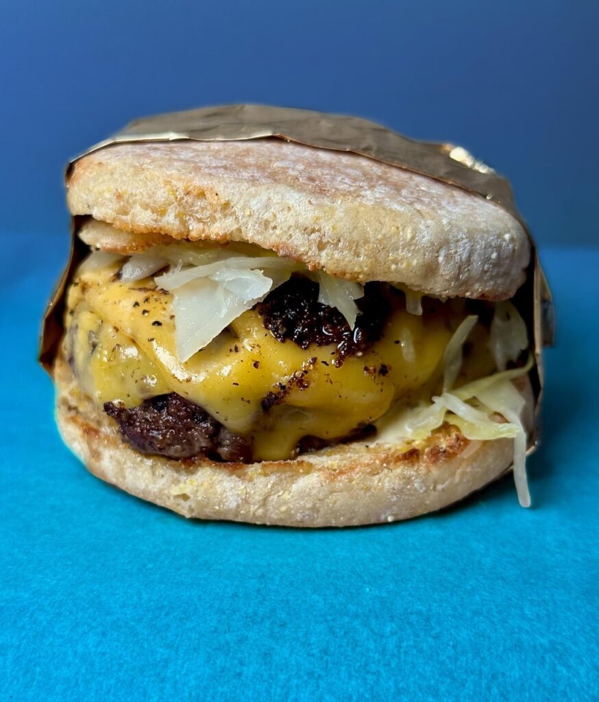 1/3lb patty, English muffin American cheese, fresh kraut, Kewpie.