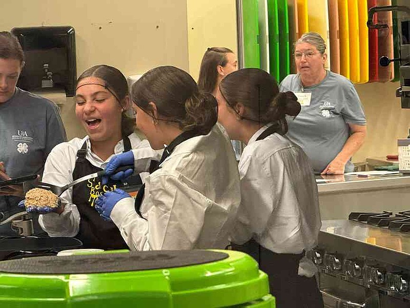The Saucy Bosses work to get their dish completed during the Arkansas 4-H Food Challenge, which was held earlier this month. The Union County trio finished third in the Junior Division. Sarah Saffold/Special to the News-Times