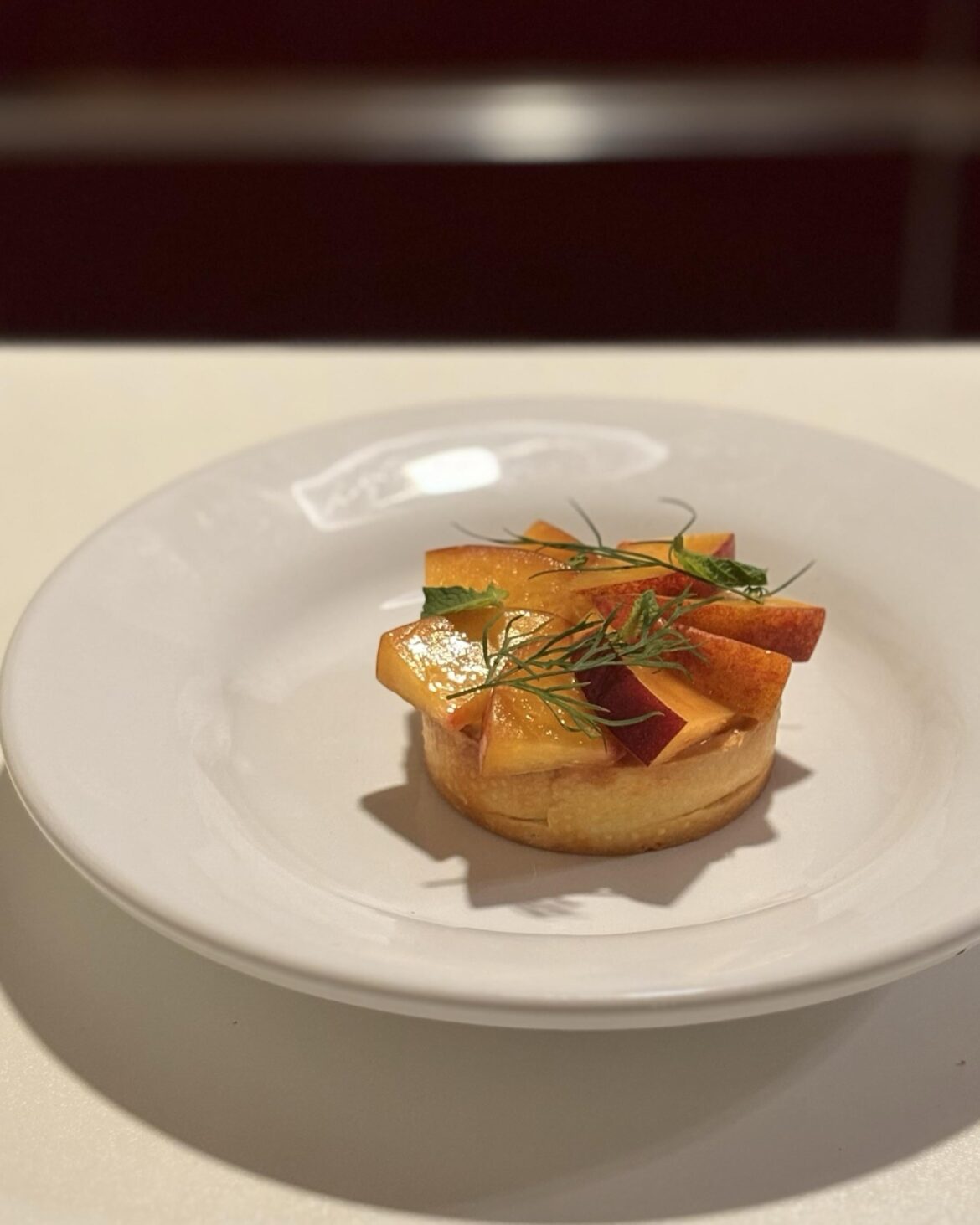 Fermented peach tartlet,  custard, mint and dill