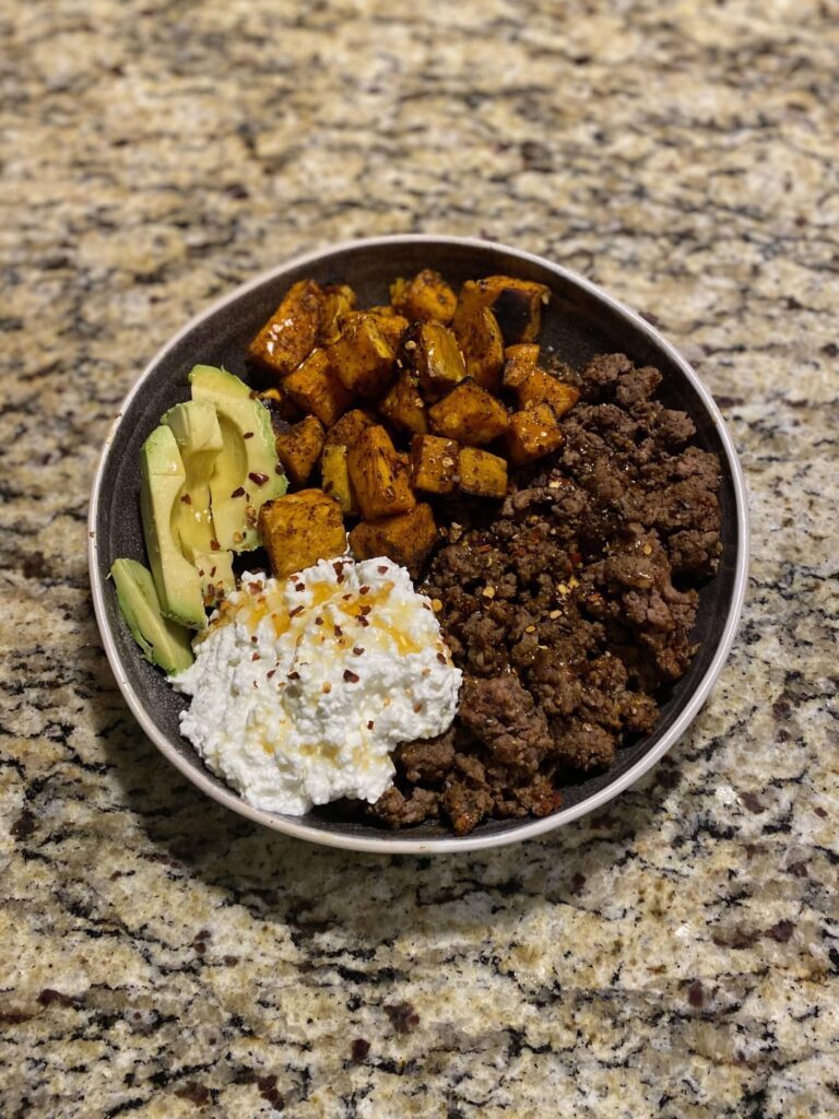 Seasoned ground beef, roasted sweet potatoes, cottage cheese, avocado, honey, and crushed red pepper
