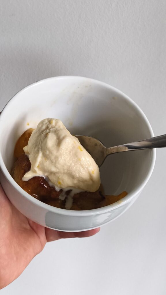 Vanilla ice cream with peach cobbler bits on peach cobbler