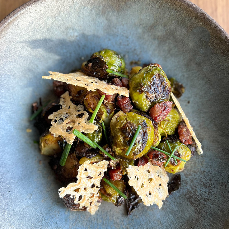 Pausa's brussels sprouts, house made guanciale, taggiasca olive vinaigrette, parmigiano crumble, chives © Carla Serrão/Pausa