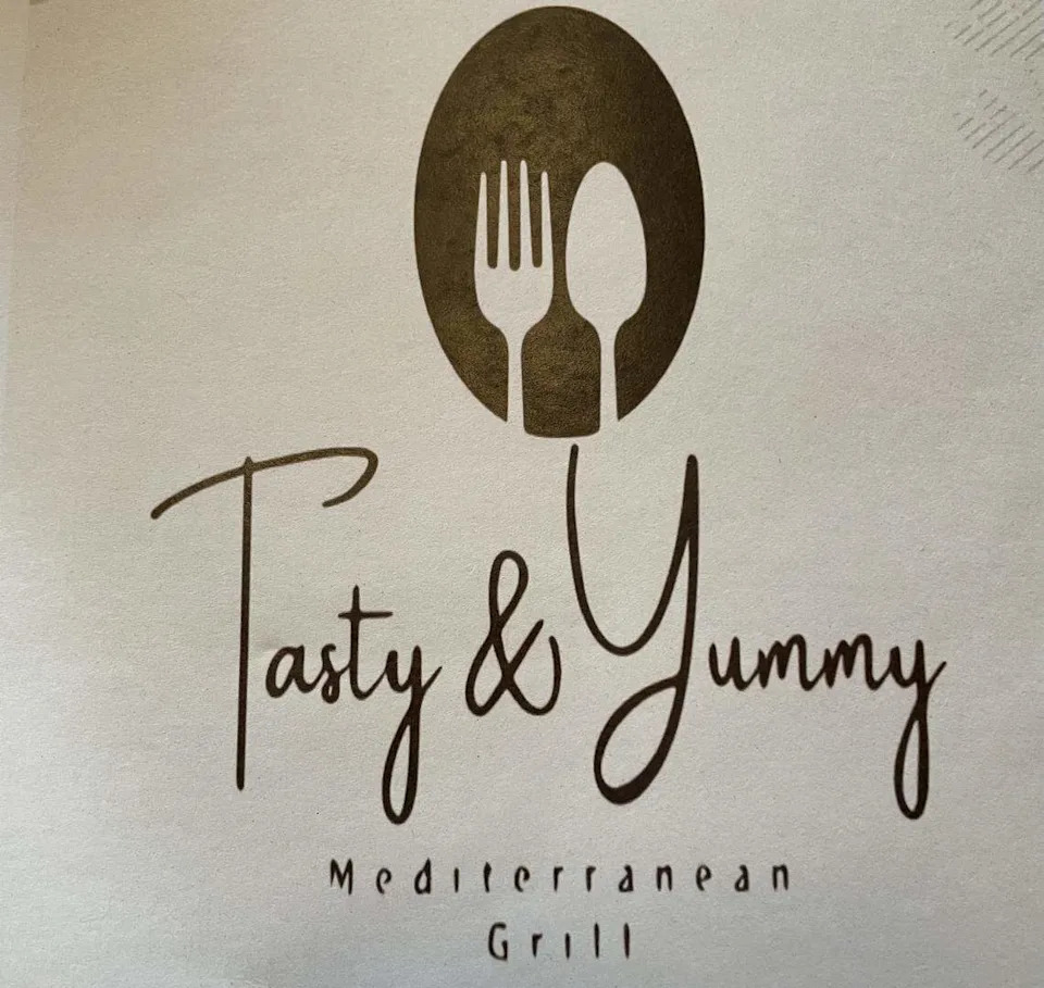 Tasty & Yummy Mediterranean Grill logo on the front of the menu.