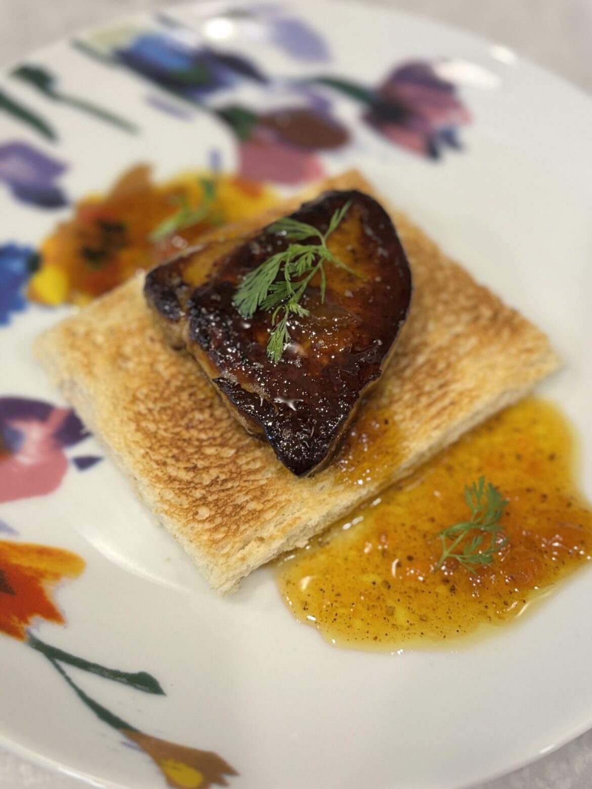Pan seared foie gras with apricot chili oil and micro cilantro