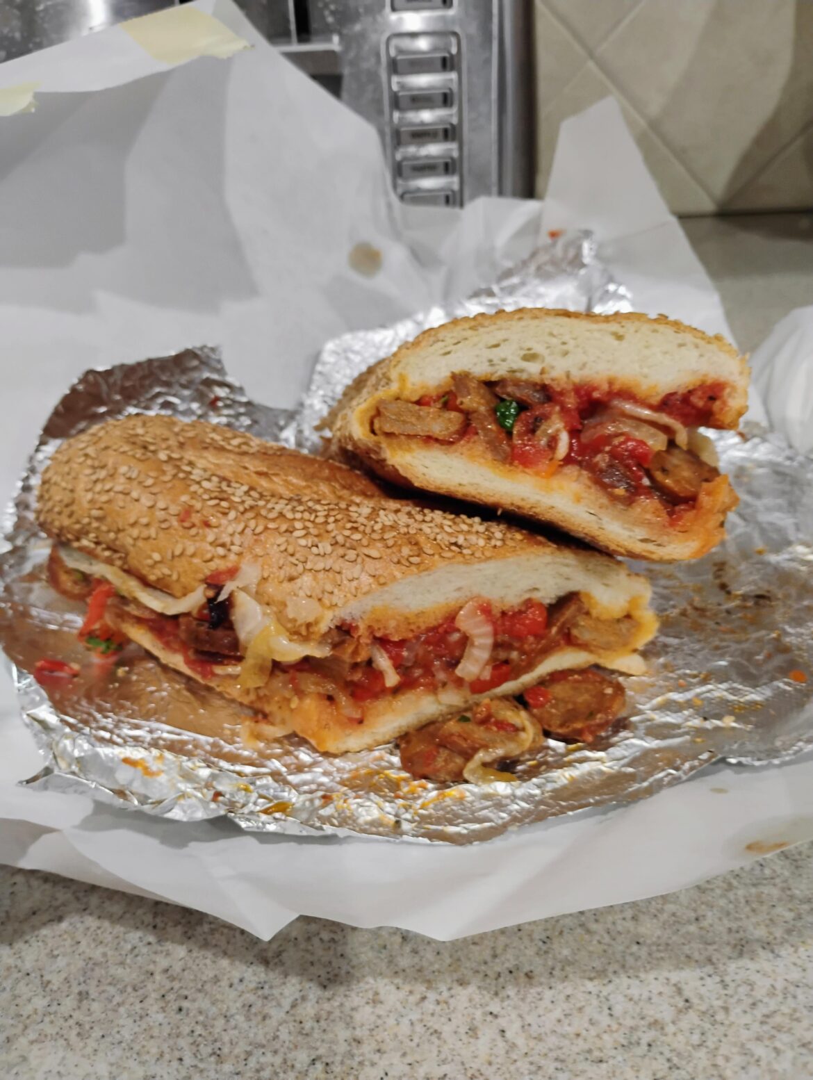 Hot Sausage & Peppers w/ house marinara on seeded Liscio's roll