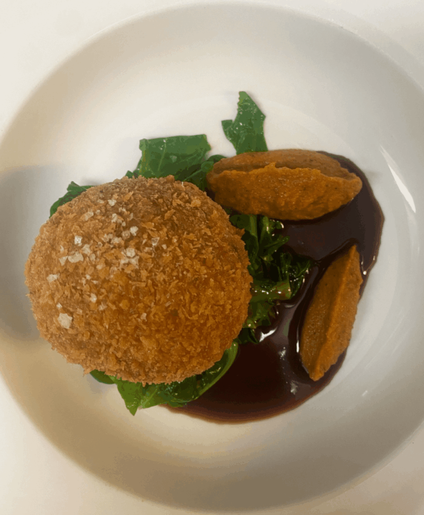 Sage and black pudding scotch egg, Burnt Carrott puree, spring greens, red wine jus