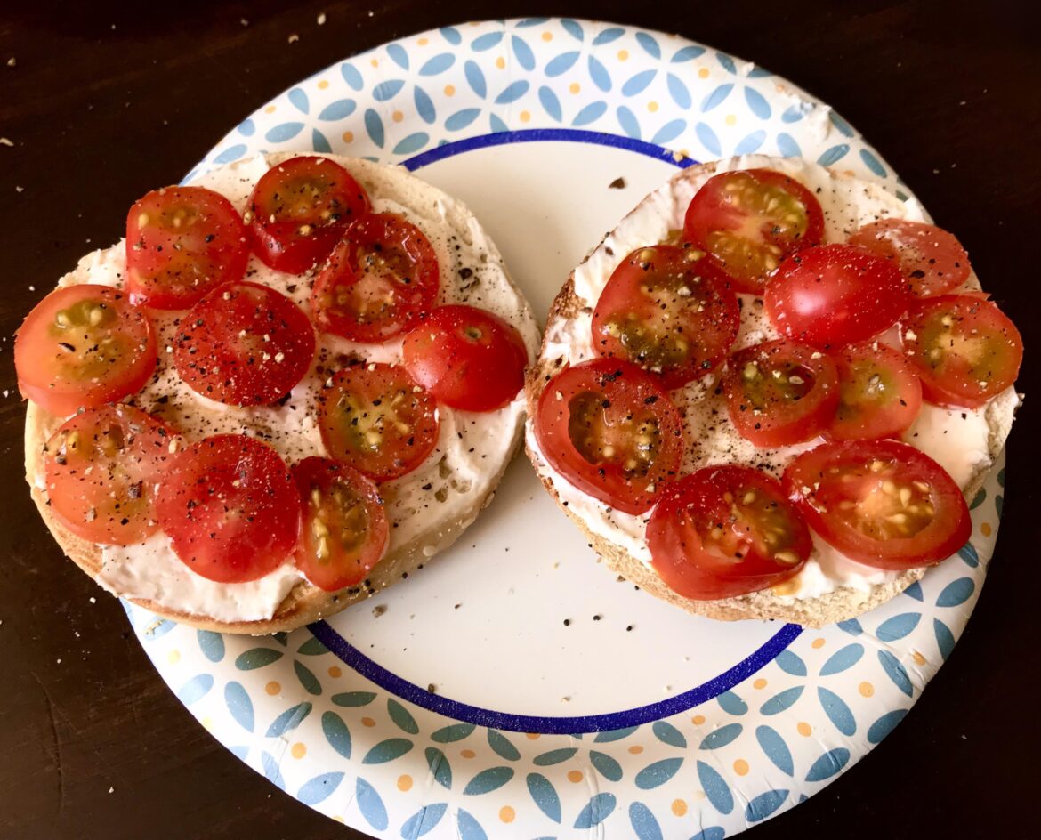 Breakfast- Cherry tomatoes with crushed black pepper and cream cheese on a Bagel.