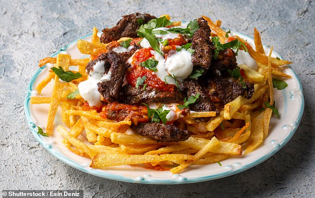 Çökertme kebab¿ - a traditional Turkish kebab made up of marinated strips of veal, fried potatoes, tomato sauce, and yogurt - secured seventh place in the ultimate guide (stock photo)