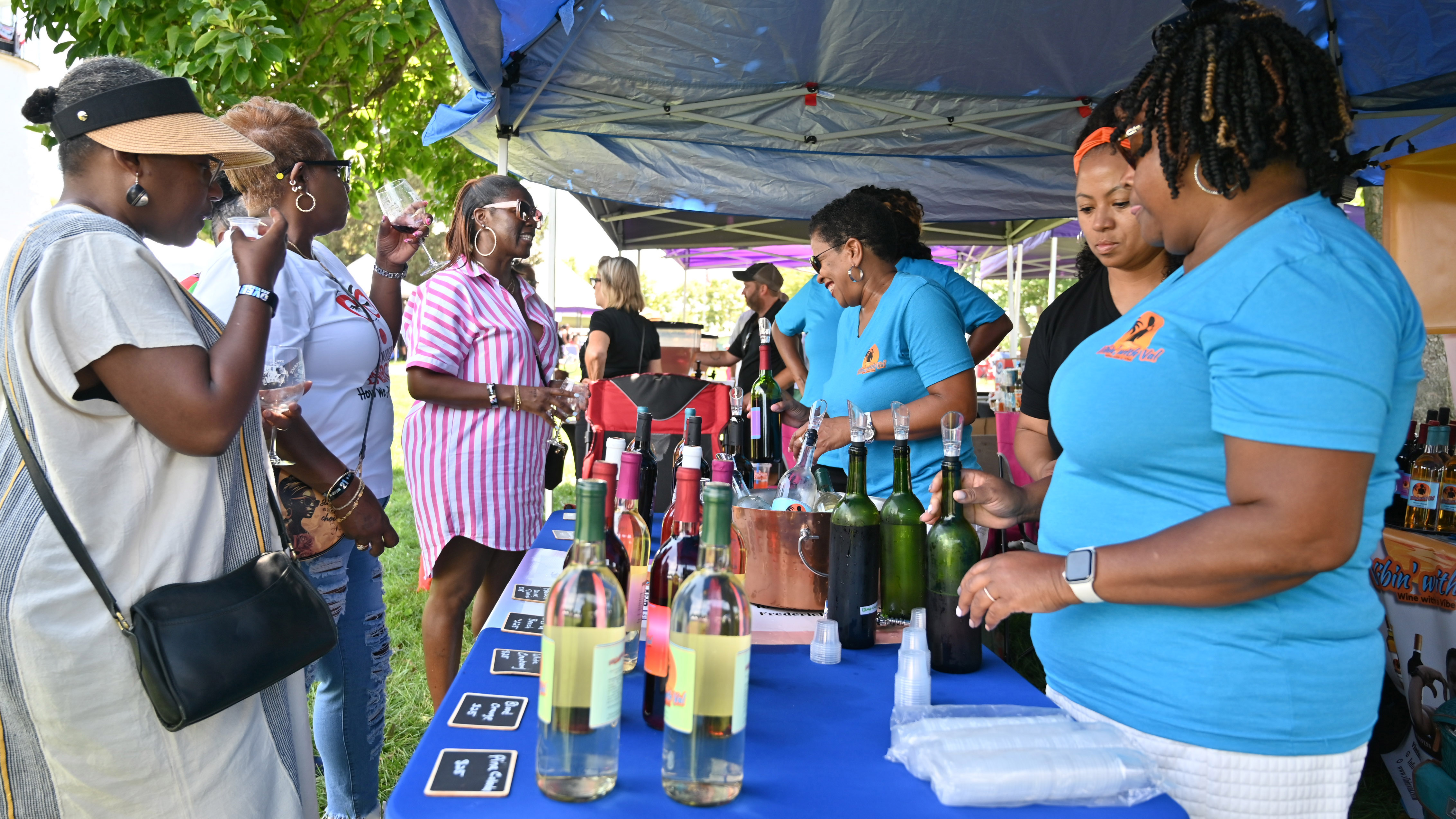 People sample wine offerings from a vendor during the Arts, Wine, Jazz & Soul Festival in Havre de Grace on Saturday. Proceeds from the event benefit the Havre de Grace Colored School Foundation. (Brian Krista/Staff)