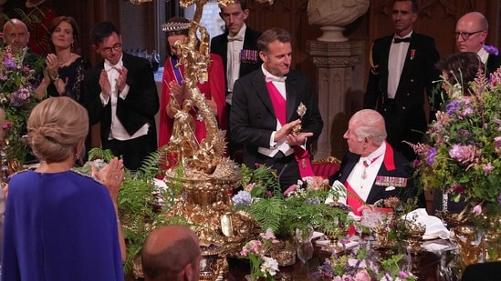 France's President Emmanuel Macron (L) applauds after Britain's King Charles III delivered a speech during a State Banquet at Windsor Castle, west of London, on July 8, 2025, on the first day of a three-day state visit to Britain.(AFP)