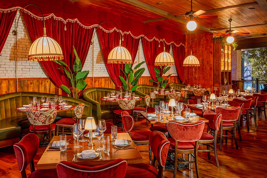 Red and green velvet decor fills a restaurant space.
