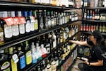A worker restocks Italian olive oil at Claro's Italian Market in Arcadia, California.