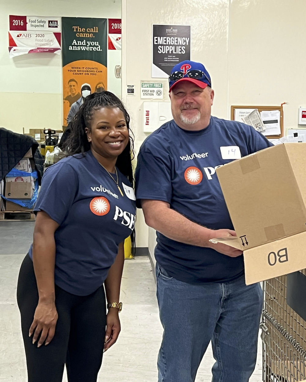 Two volunteers smiling