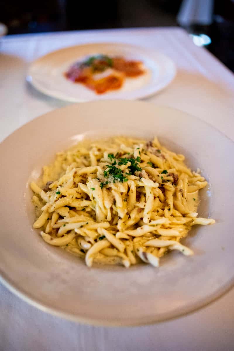 aaste erbe aromatiche, a discreet pasta with strozzapreti noodles in a parmesan cream sauce with bits of prosciutto, leeks, and fresh aromatic herbs by Franco's Italian Caffe