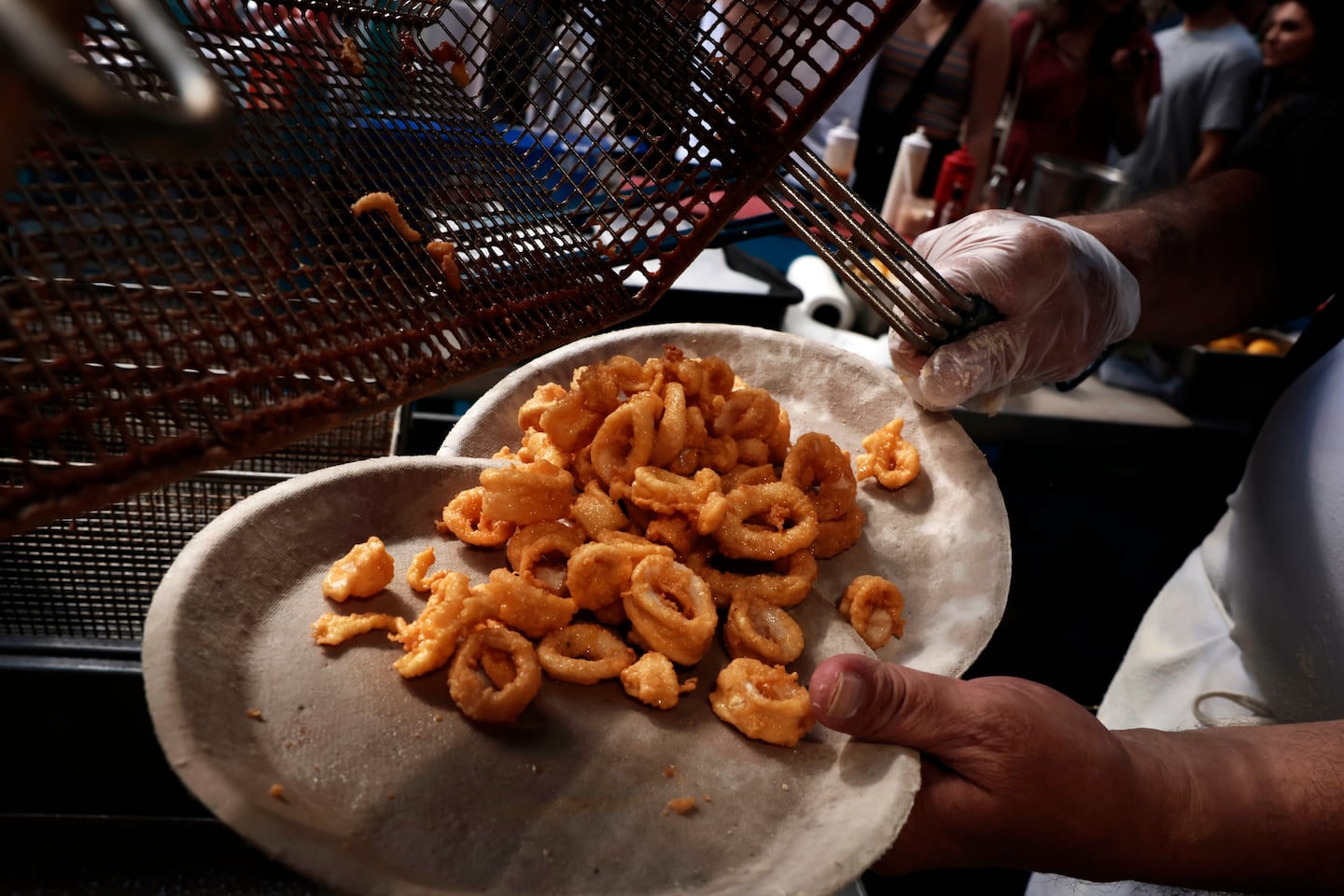 Rick Pezzano prepared a plate at the Boston Fried Calamari booth during St. Anthony's Feast in the North End. 