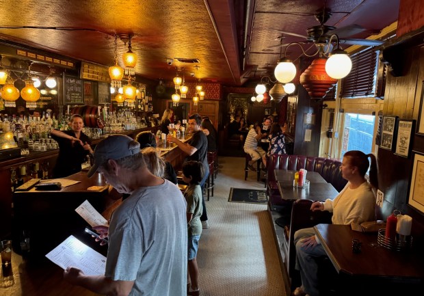 Customers examine menus or await their orders on Sunday afternoon at Cole's French Dip, which has been in the same location in downtown L.A. since 1908. The restaurant and bar is due to close in mid-Sept.. (Photo by David Allen, Inland Valley Daily Bulletin/SCNG)