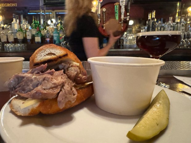 A half-size pork dip sandwich and cup of au jus await at Cole's French Dip, a downtown L.A. restaurant and bar that has a claim on having invented the French dip. Cole's, open since 1908, is due to close in mid-Sept.. (Photo by David Allen, Inland Valley Daily Bulletin/SCNG)