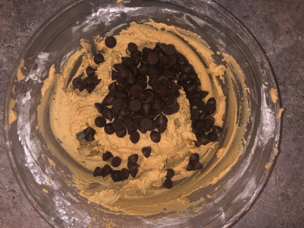 Adding in chocolate chips to the dough.