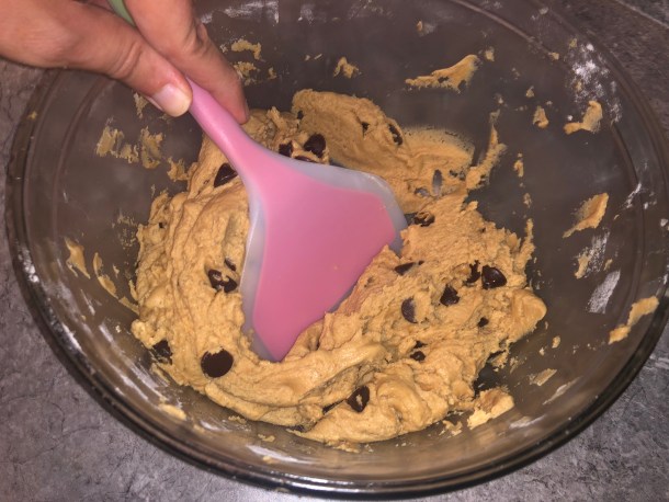Folding the chocolate chips into the dough.