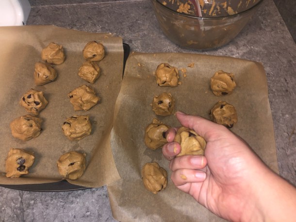 Rolling up the dough into balls.