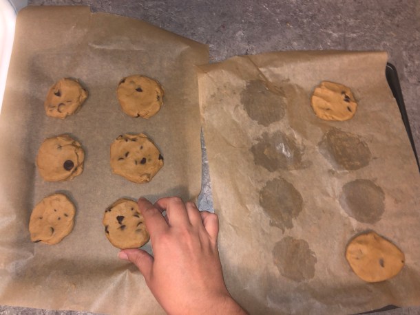 Moving the chilled dough over to a new baking sheet.