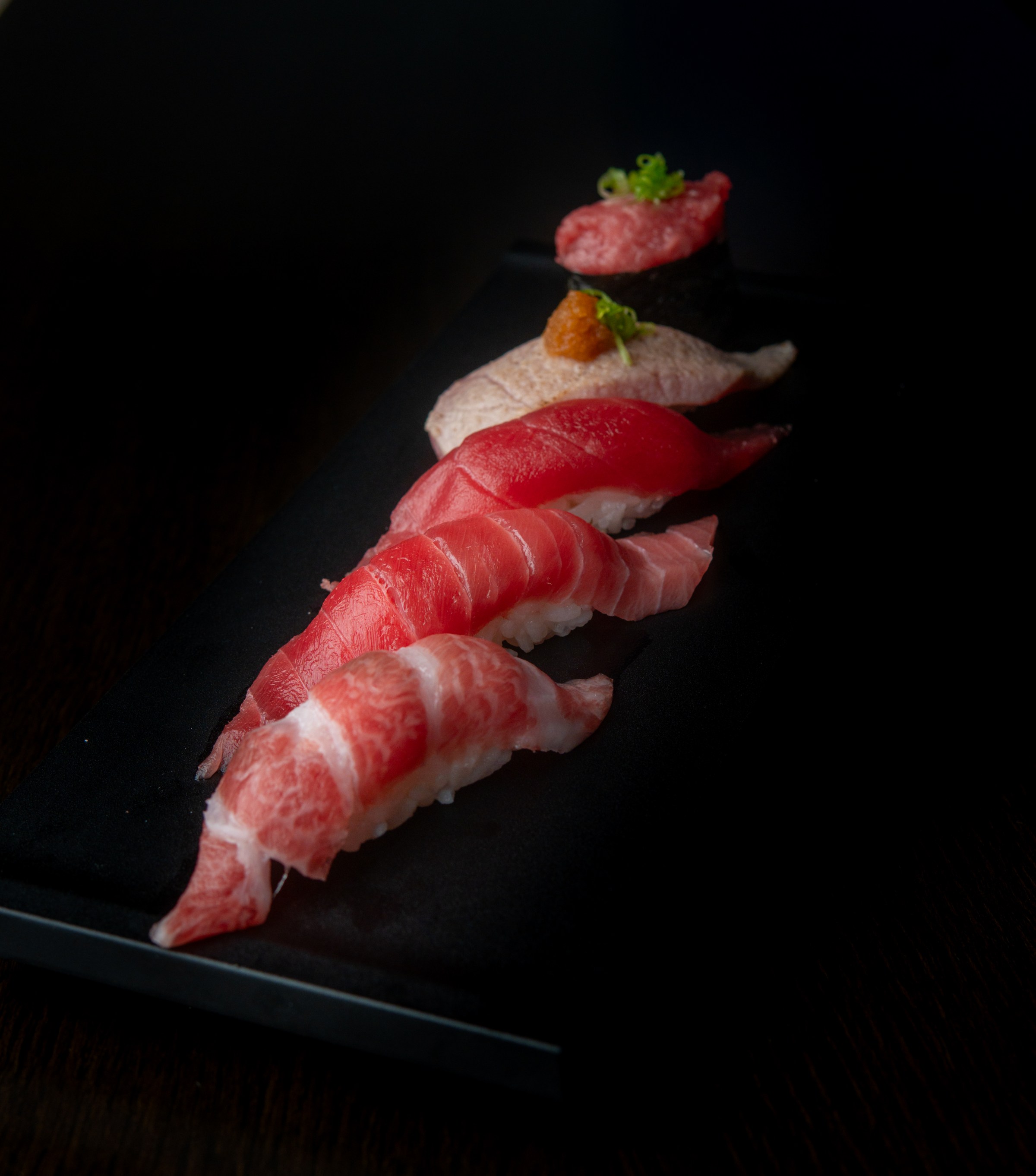 Nigiri on a black plate from Sushi Zanmai