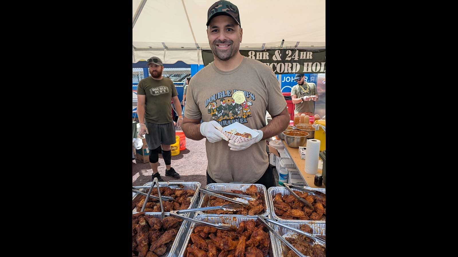 Dallas Lopez of Laramie's Double Dub's dishing up a Spicy Bleu 17 wing made famous by Josh Allen.