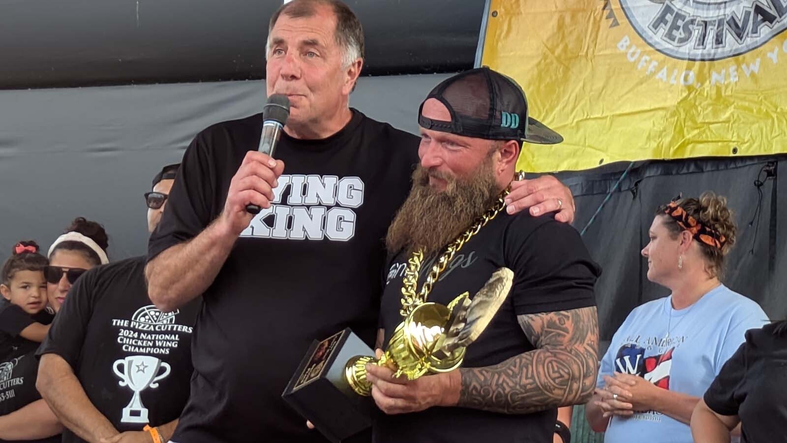 Festival organizer Drew Cerza, aka the "Wing King," awarding Trent Weitzel with second place for the "creative spicy" category.