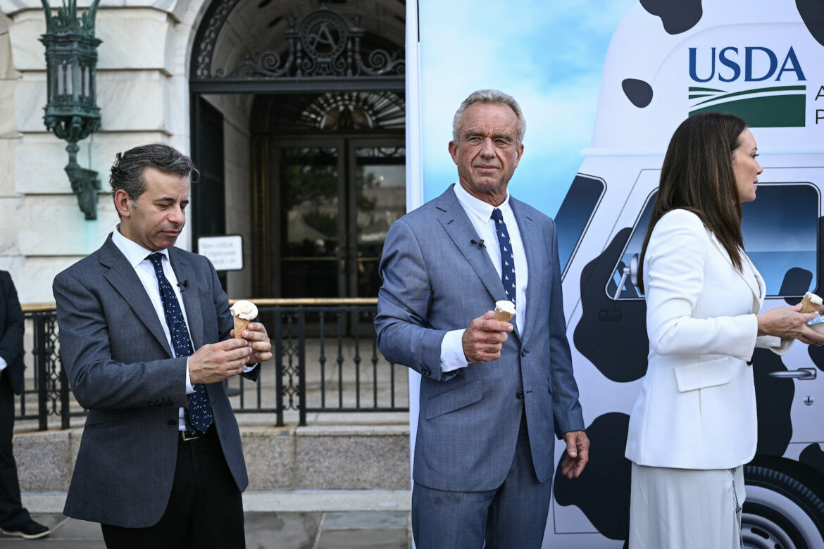 (L/R) Food and Drug Administration Commissioner (FDA) Martin Makary, Secretary of Health and Human Services Robert F. Kennedy Jr., and Secretary of Agriculture Brooke Rollins eat ice cream at the end of a news conference at the USDA headquarters building in Washington, DC. (Brendan SMIALOWSKI / AFP via Getty)