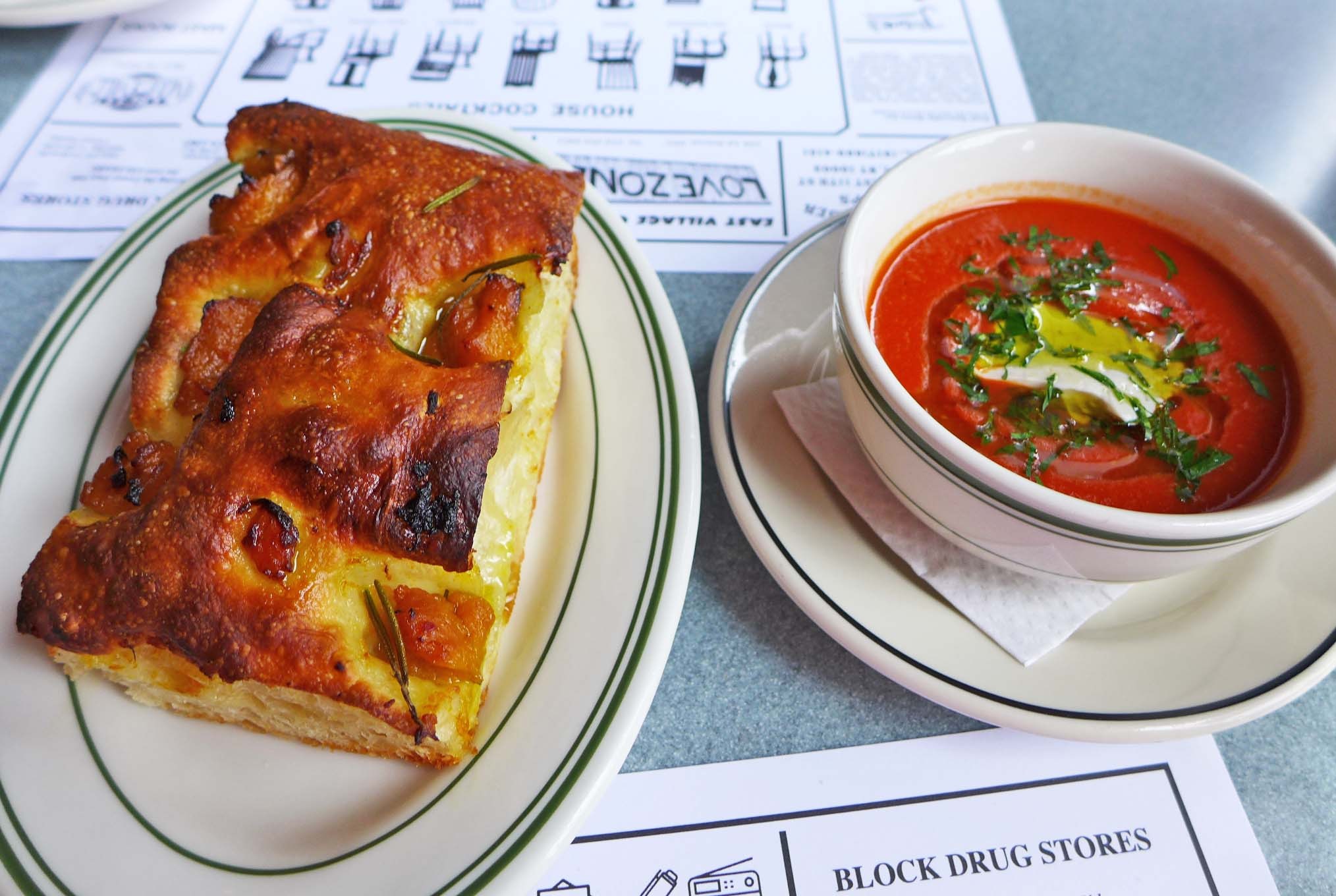 A browned rectangle of thick bread and a small bowl of bright red soup.