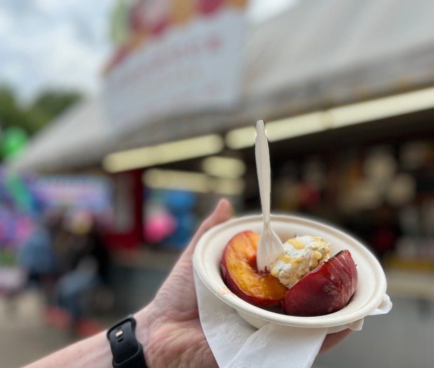 A grilled peach with a dollop of white cheese and a honey drizzle