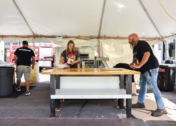 Workers set up equipment for Revello’s to prepare for La...