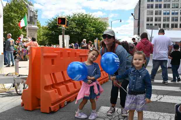 Melina Roldan, 4, and her sister Naylene Roldan, 3, hold...