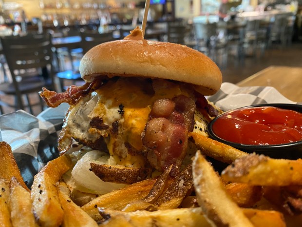 At Torch Bistro, the Sweepstakes is a large burger served on a sesame roll, and topped with all sorts of delicious things: house-made pimento cheese, applewood bacon, lettuce and a fried egg. All of the elements are pulled together with the lip-smacking Torch Sauce. (Patrick Evans-Hylton / freelance)