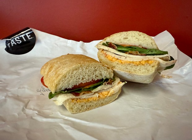 At gourmet grocer Taste, the Lynnhaven sandwich is a large offering of ciabatta bread spread with house-made Sassy Southern pimento cheese and stuffed with heated, roasted chicken breast and hardwood smoked bacon. Baby spinach and sliced tomato garnish the dish. (Patrick Evans-Hylton / freelance)