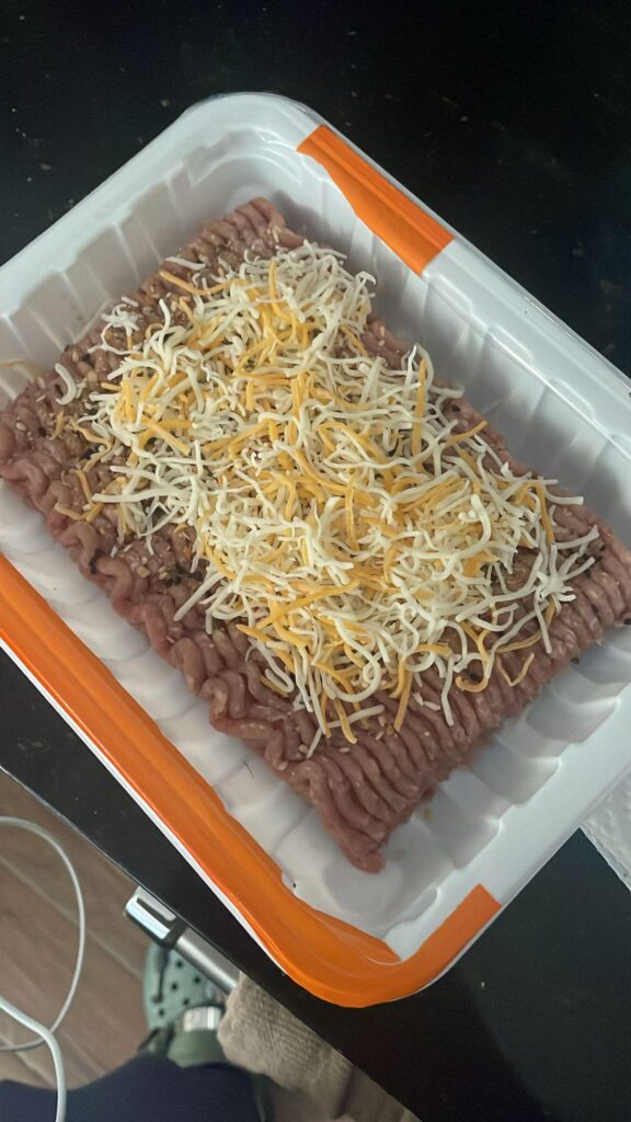 My buddy put some seasoning on it, cheese, and is gonna air fry it