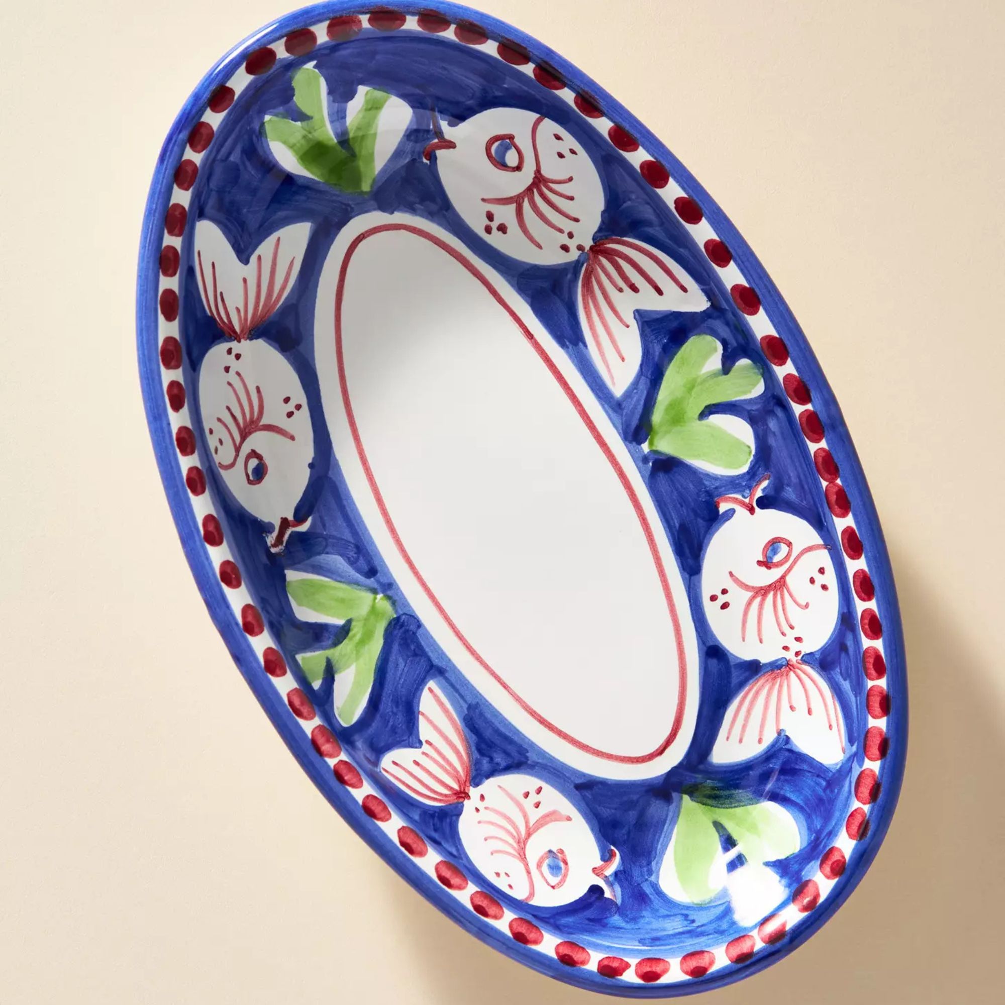 serving platter with navy rim and red fish illustrations
